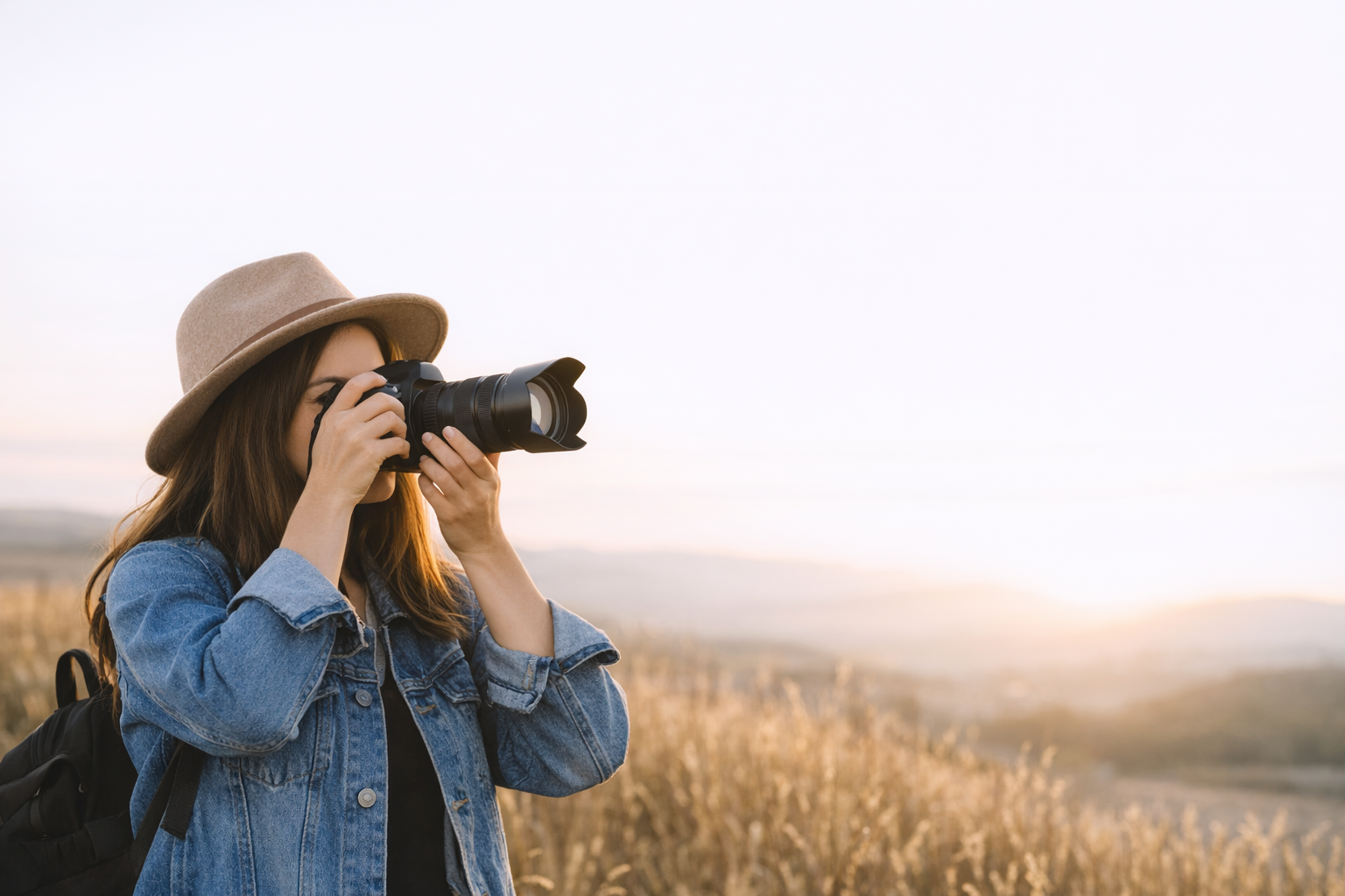 “Outdoor female photographer in Melbourne capturing photos with a DSLR camera, focusing carefully in a natural setting.”